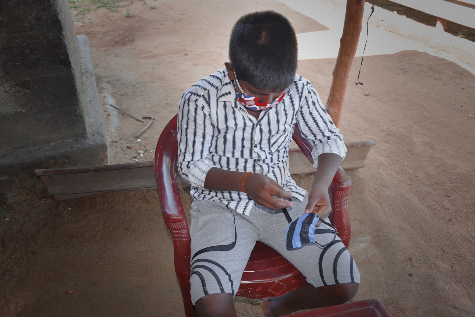 Thanusan busy with his stitching