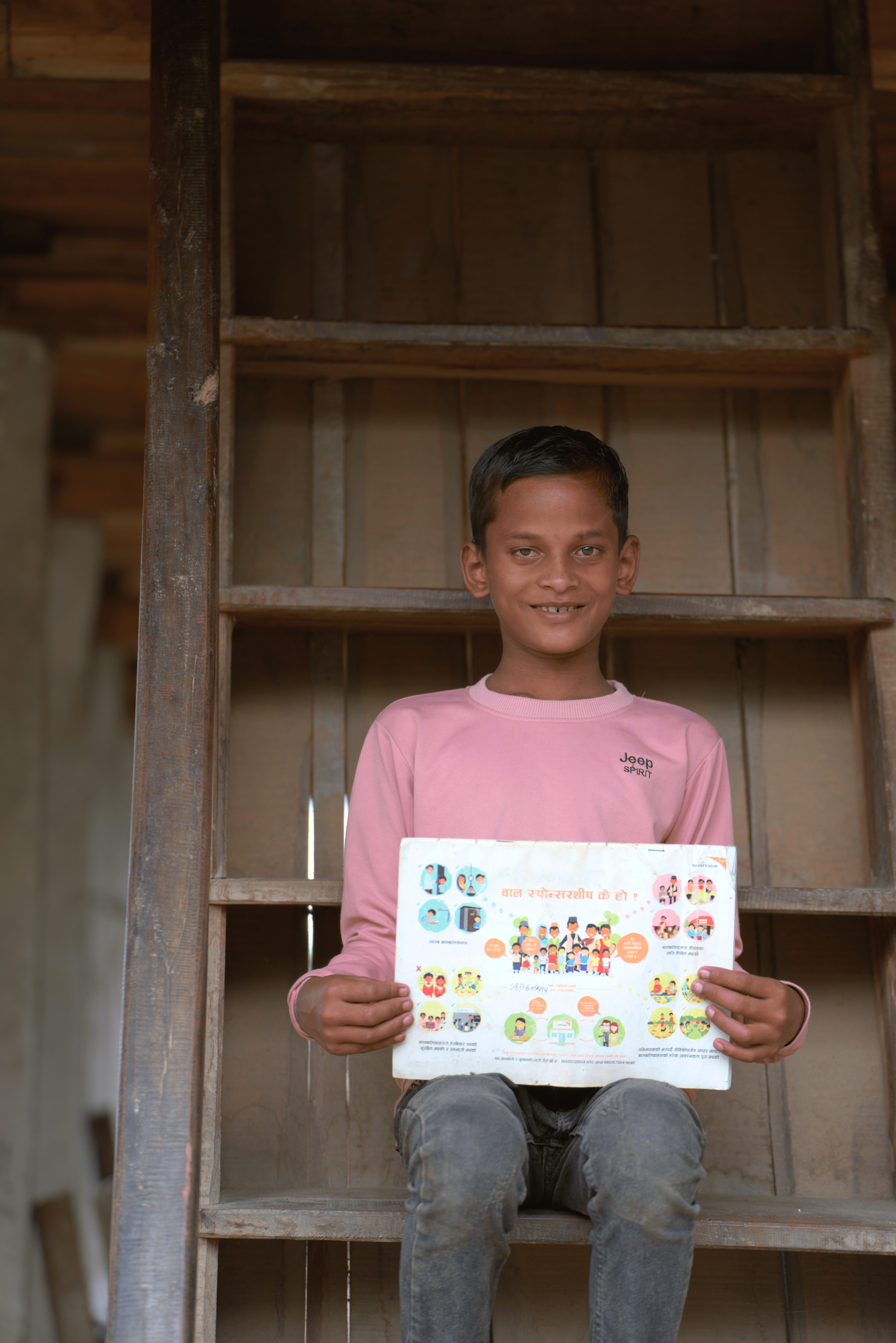 Kanchan shows his Sponsorship register provided by WVI Nepal.