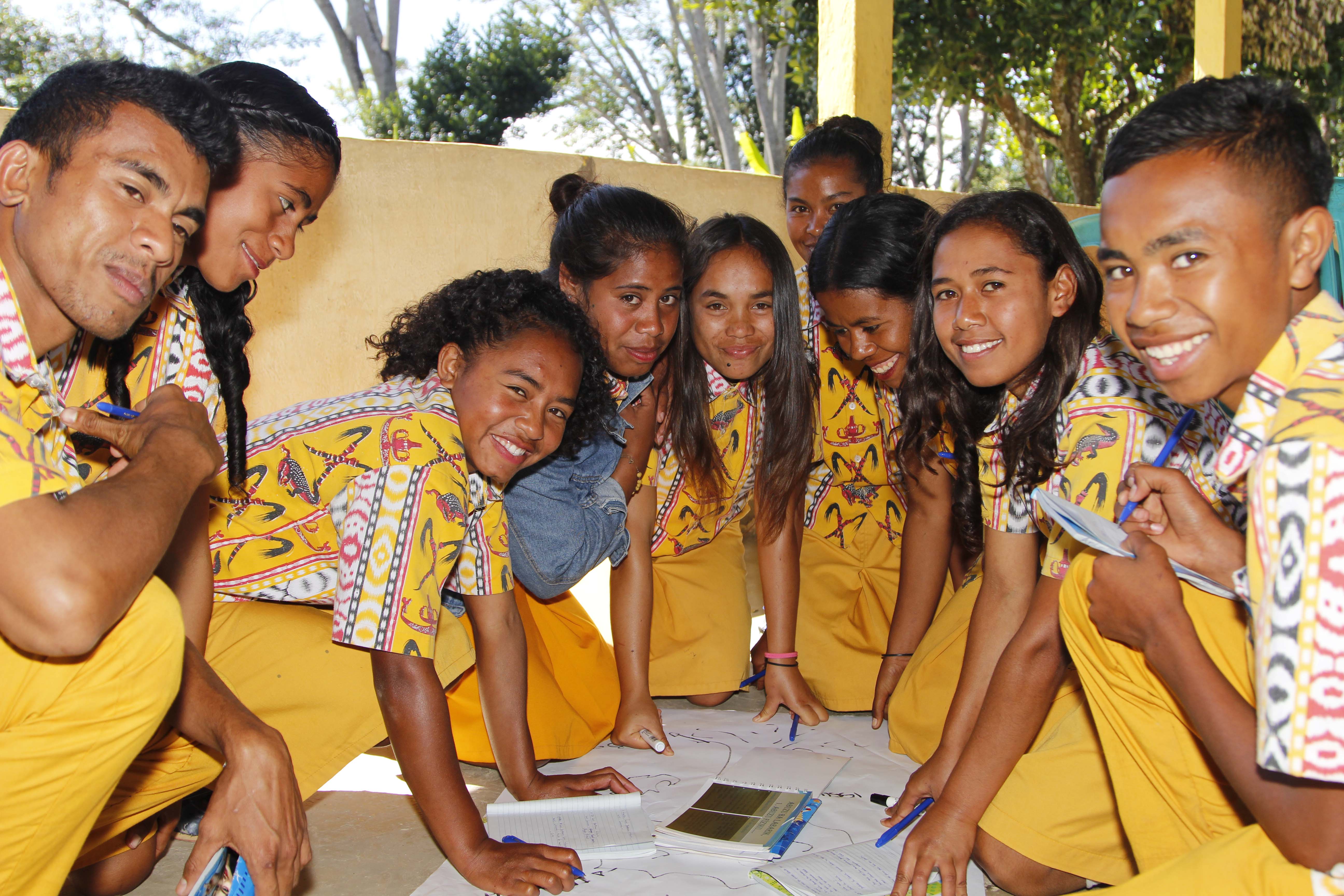 Angelina (third from left) leads students in a group discussion on gender and child protection. Photo: Jaime dos Reis/World Vision