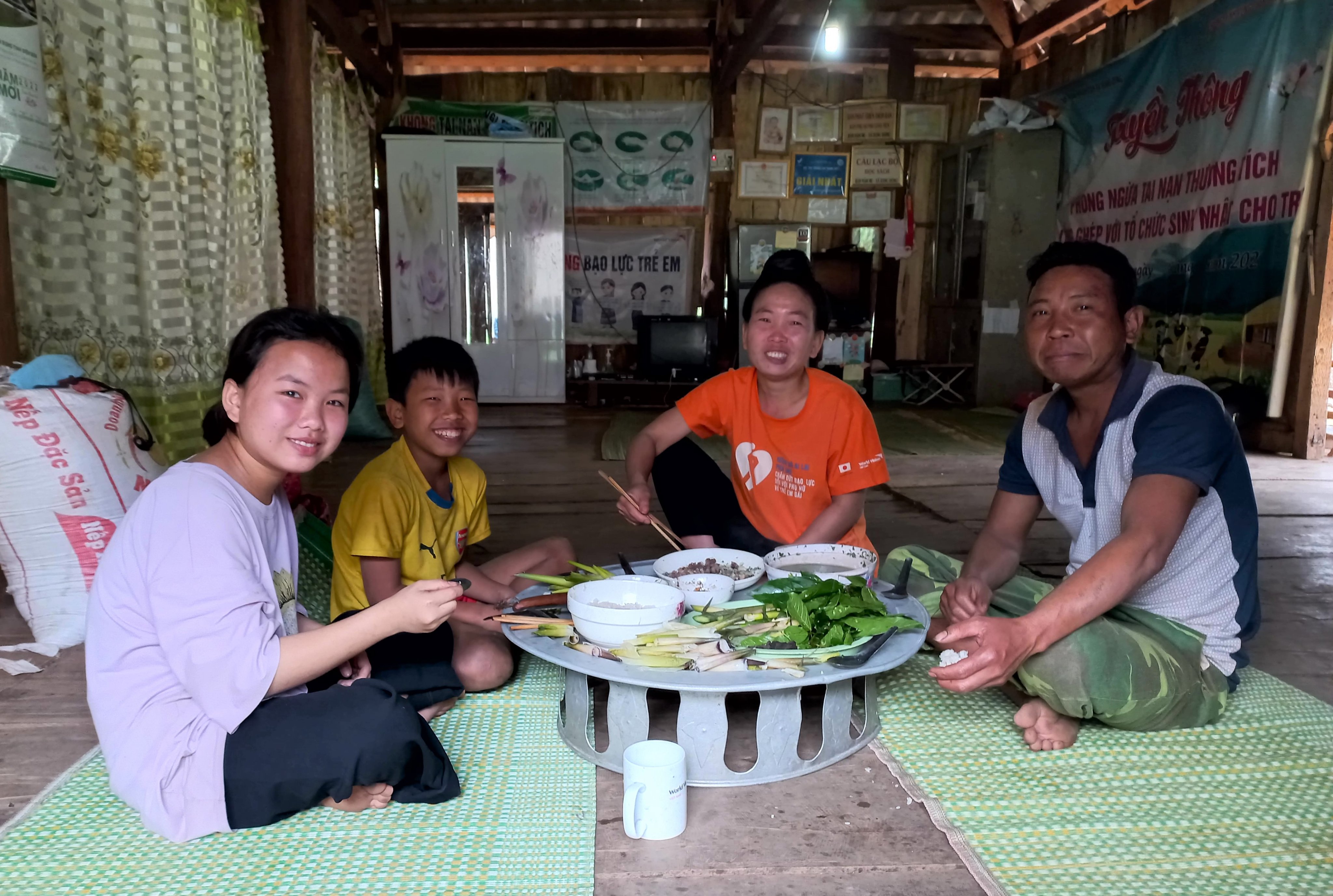 Family sits around a table eating