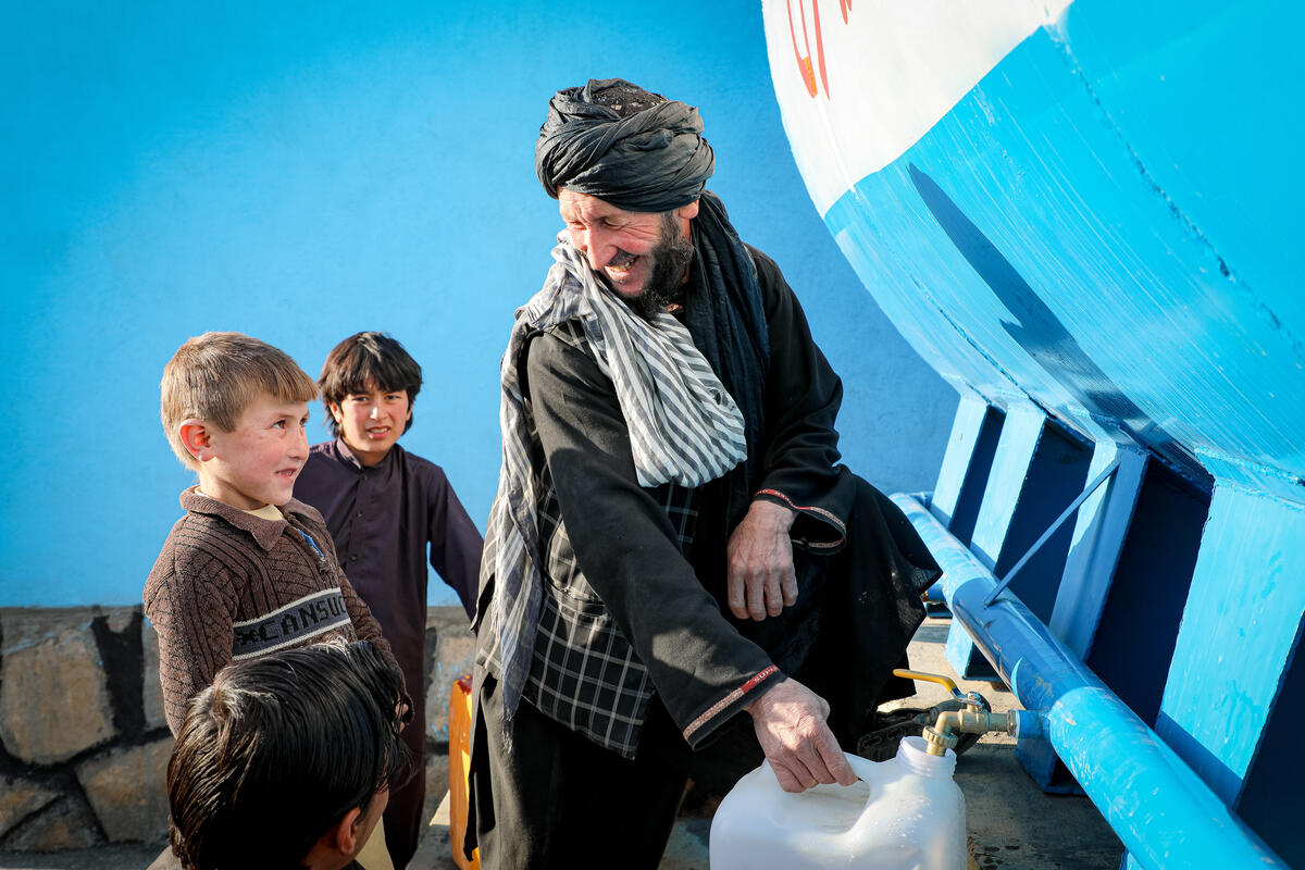 Families and children collect clean water easily now in Afghanistan thanks to joint project between World Vision and UNICEF