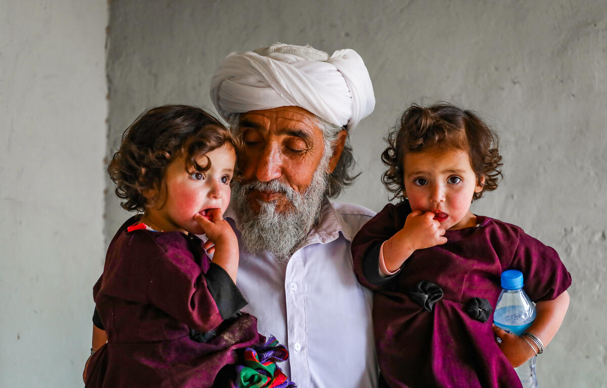 Granddad holding children