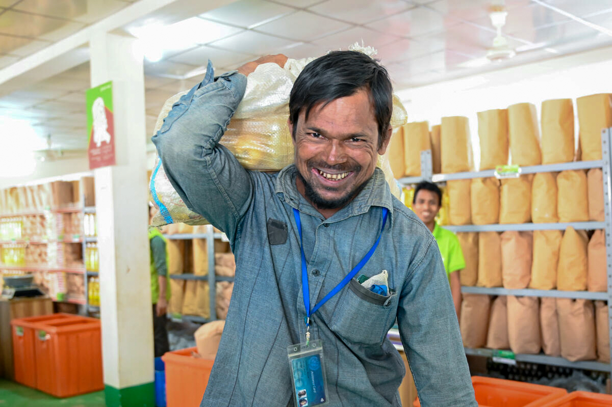 Najir carries back his food bought from E-voucher store by the food assistance card from WFP E-voucher store to his shelter.