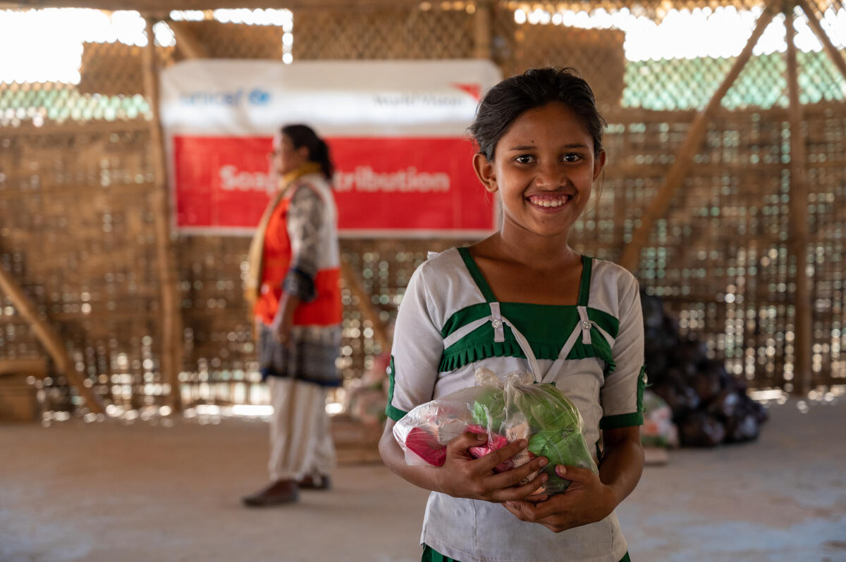 Nurankis, 11, happily receives soap for her family from World Vision.