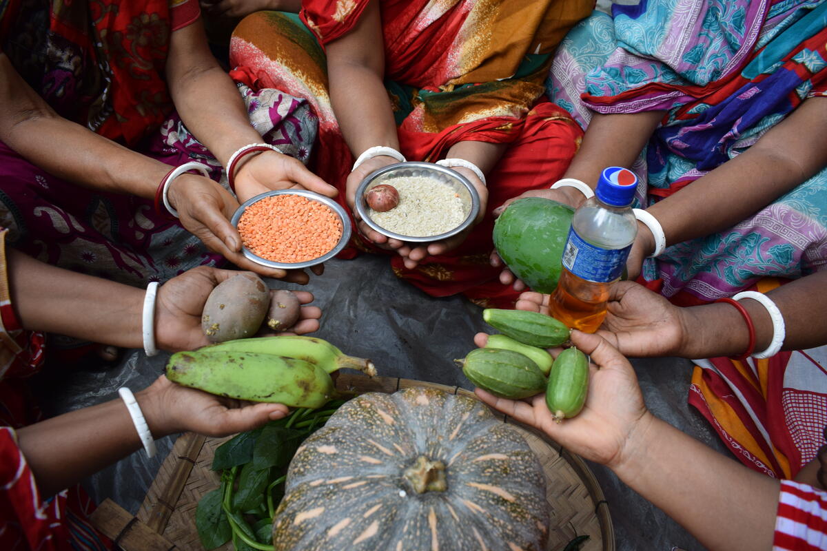 Women hold vegetables