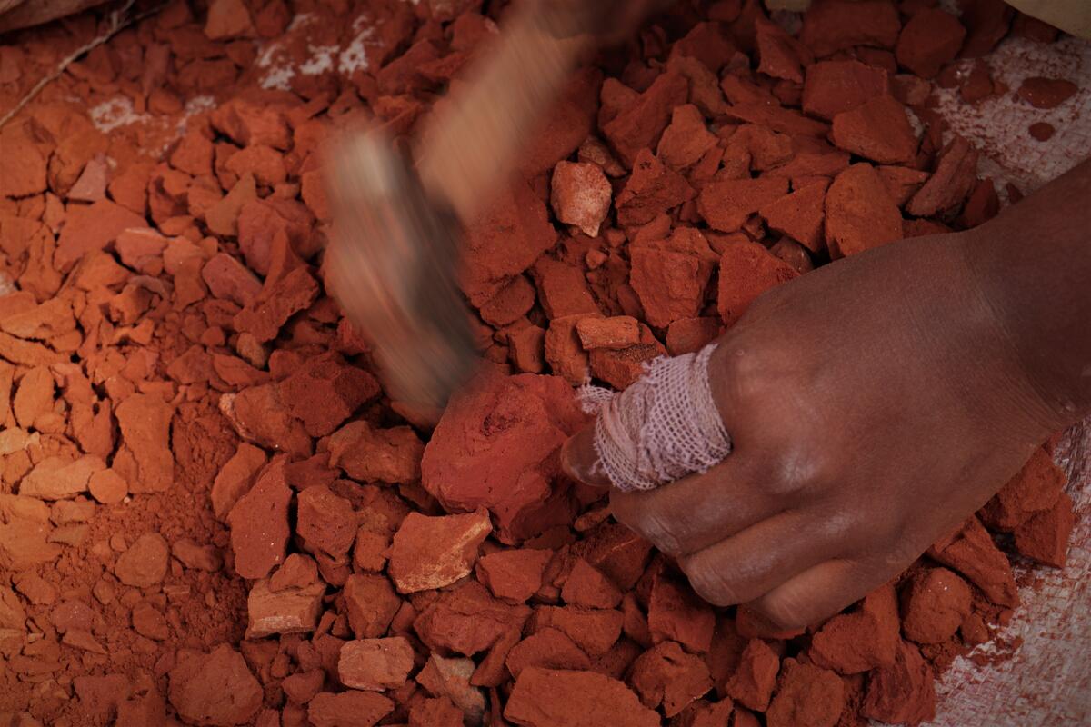 Nuri's fingers are covered in bandages from the back-breaking work.