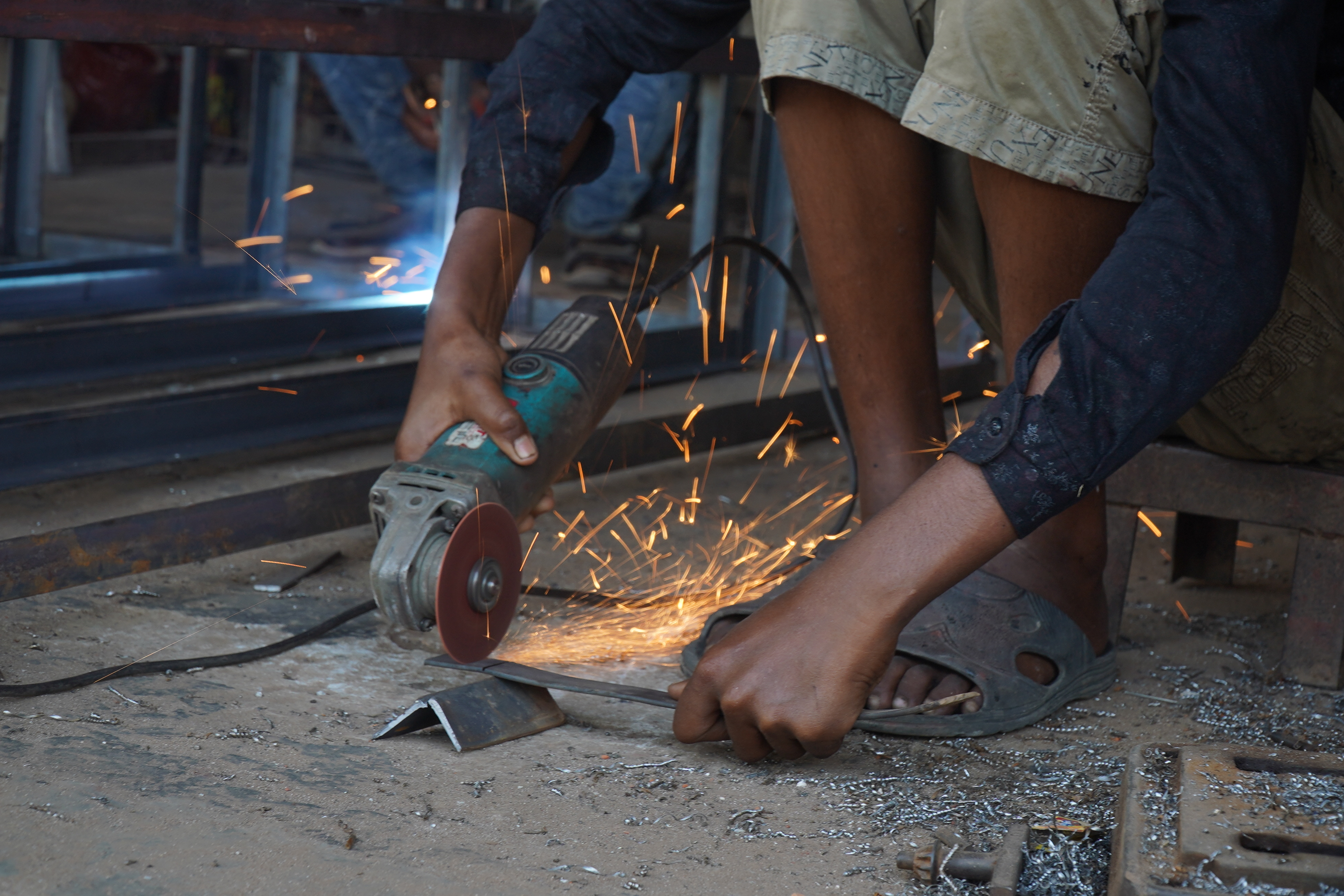 A boy  working in a welding job at Dinajpur in South Korea