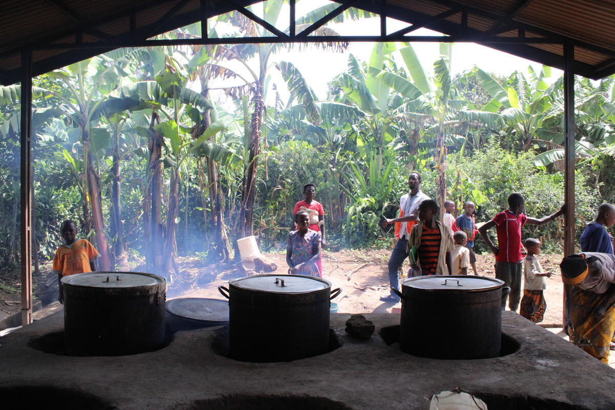 Parents cooking food that will be used by their children at lunch time, School Meals Burundi 