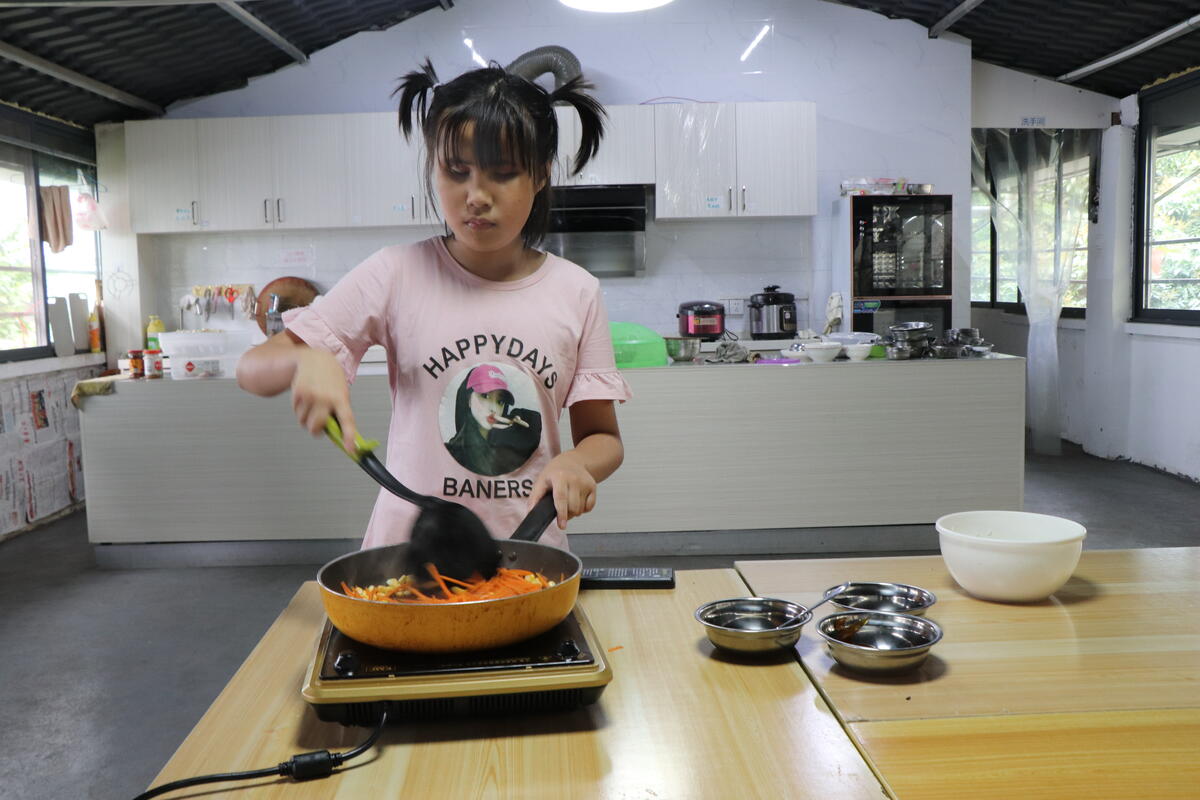 Xiaobing can cook a meal by herself thanks to her training.