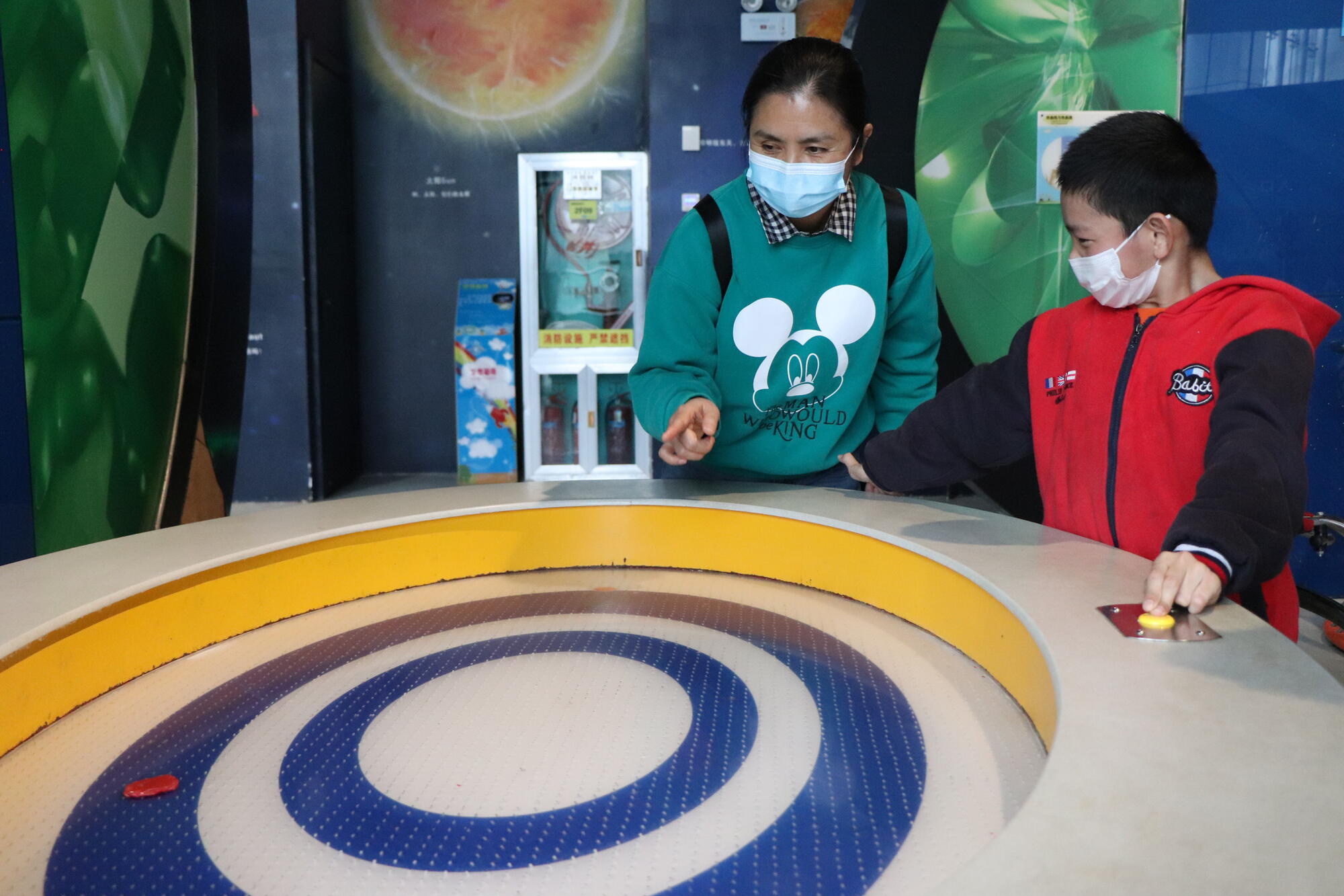 Xiao Ran trying a scientific experiment at the Science Centre