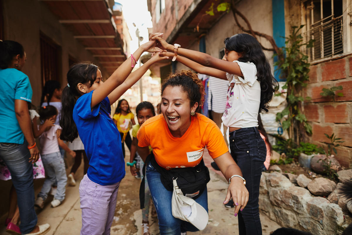 Children playing with World Vision staff in Colombia