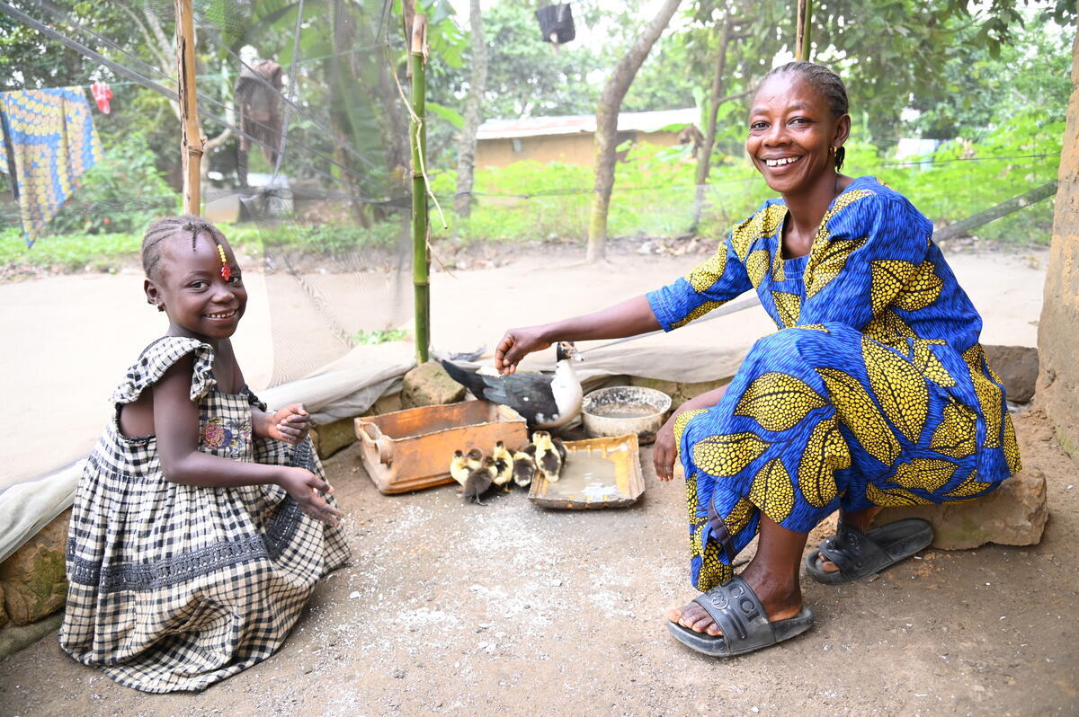 Landrine and her daughter next to their duck farm