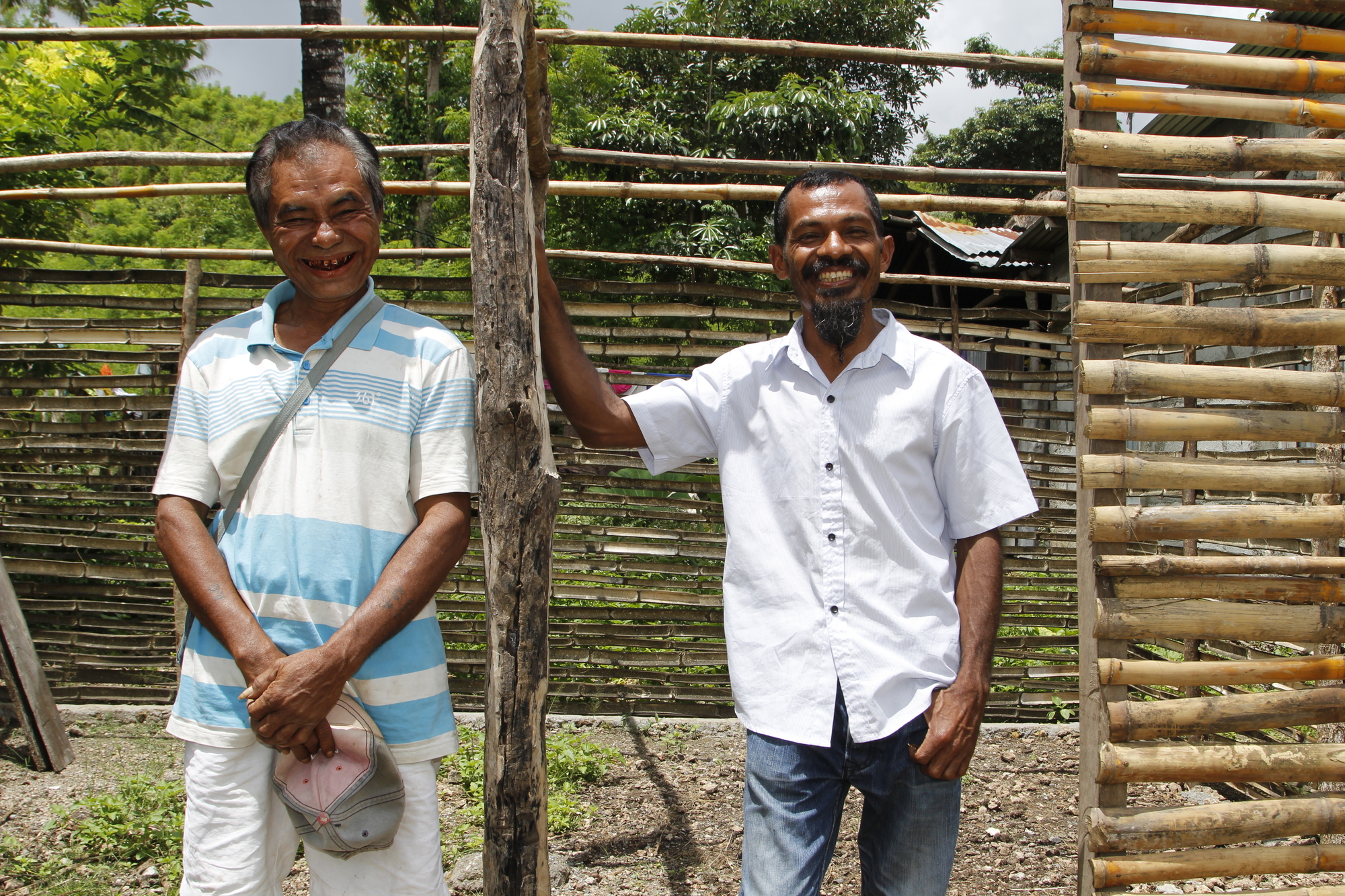 Tito (right) encouraged savings group member Jorge (left) to build his own chicken coop using local materials. Photo: Jaime dos Reis/World Vision