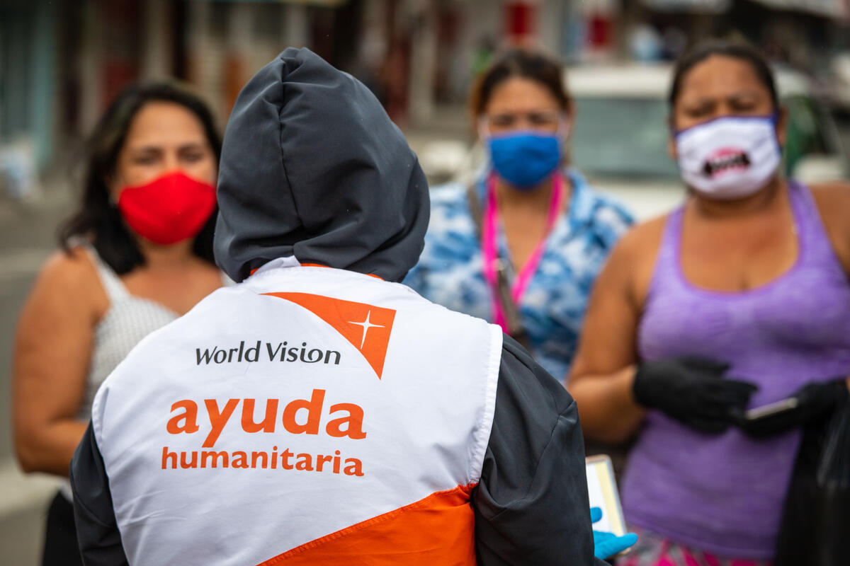 World Vision staff distribute cash cards to Venezuelan migrant families who are struggling to afford basic necessities due to COVID-19