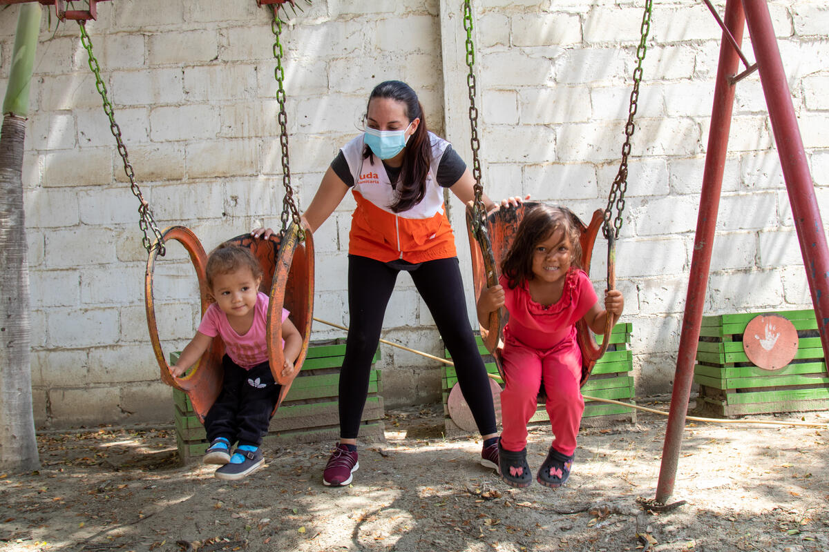 Isabela on the swings with her new friend.