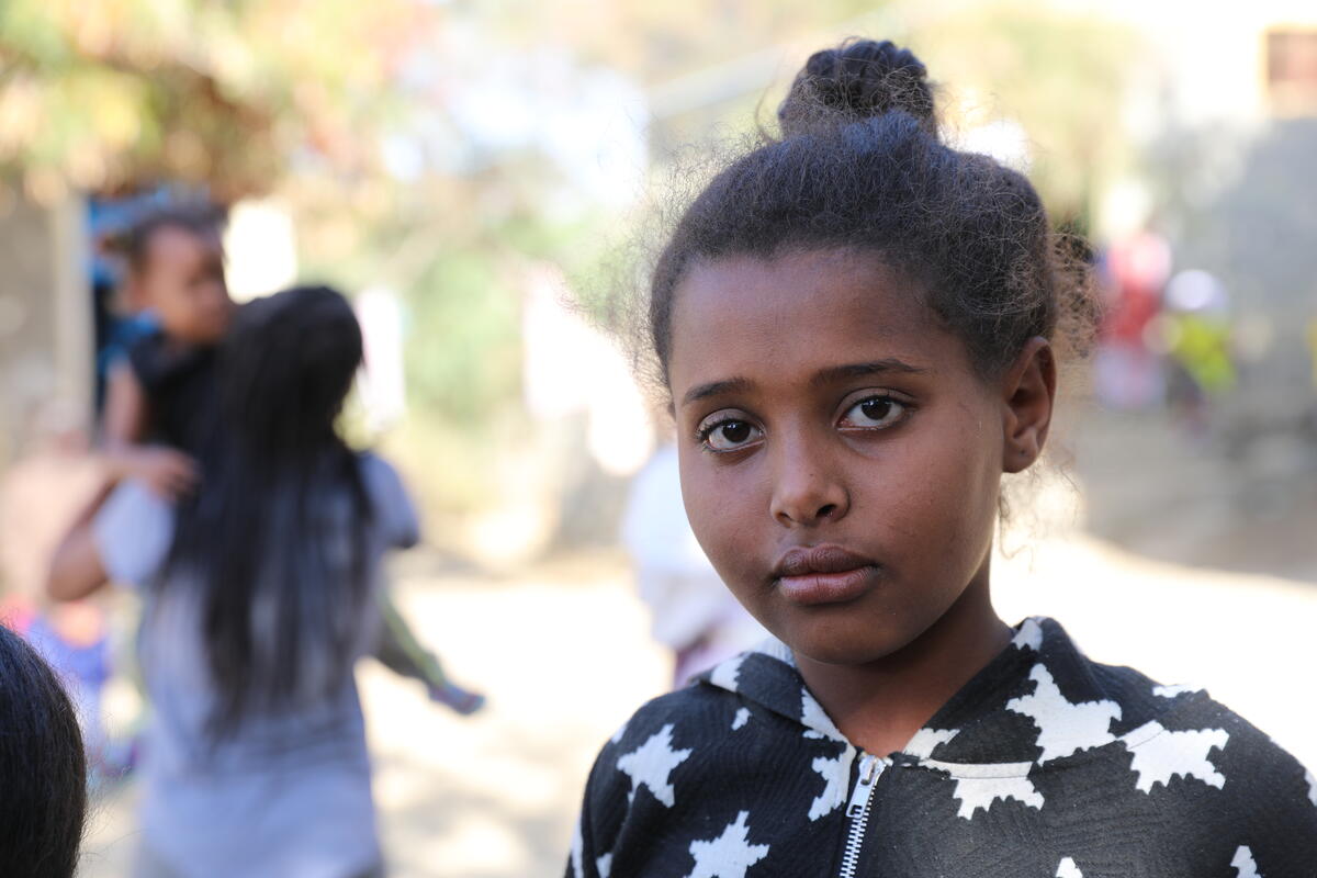 girl stands outside and stares at camera 