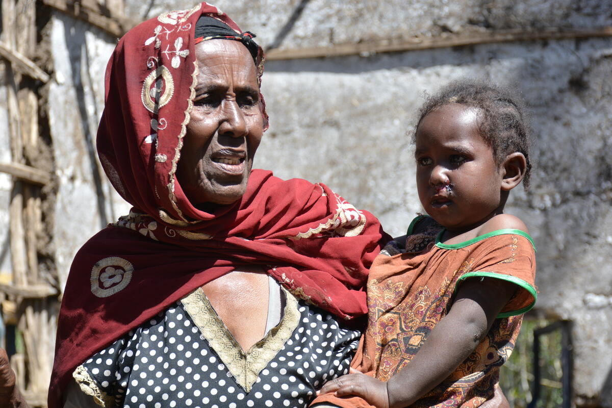 Refugee mother holds a child