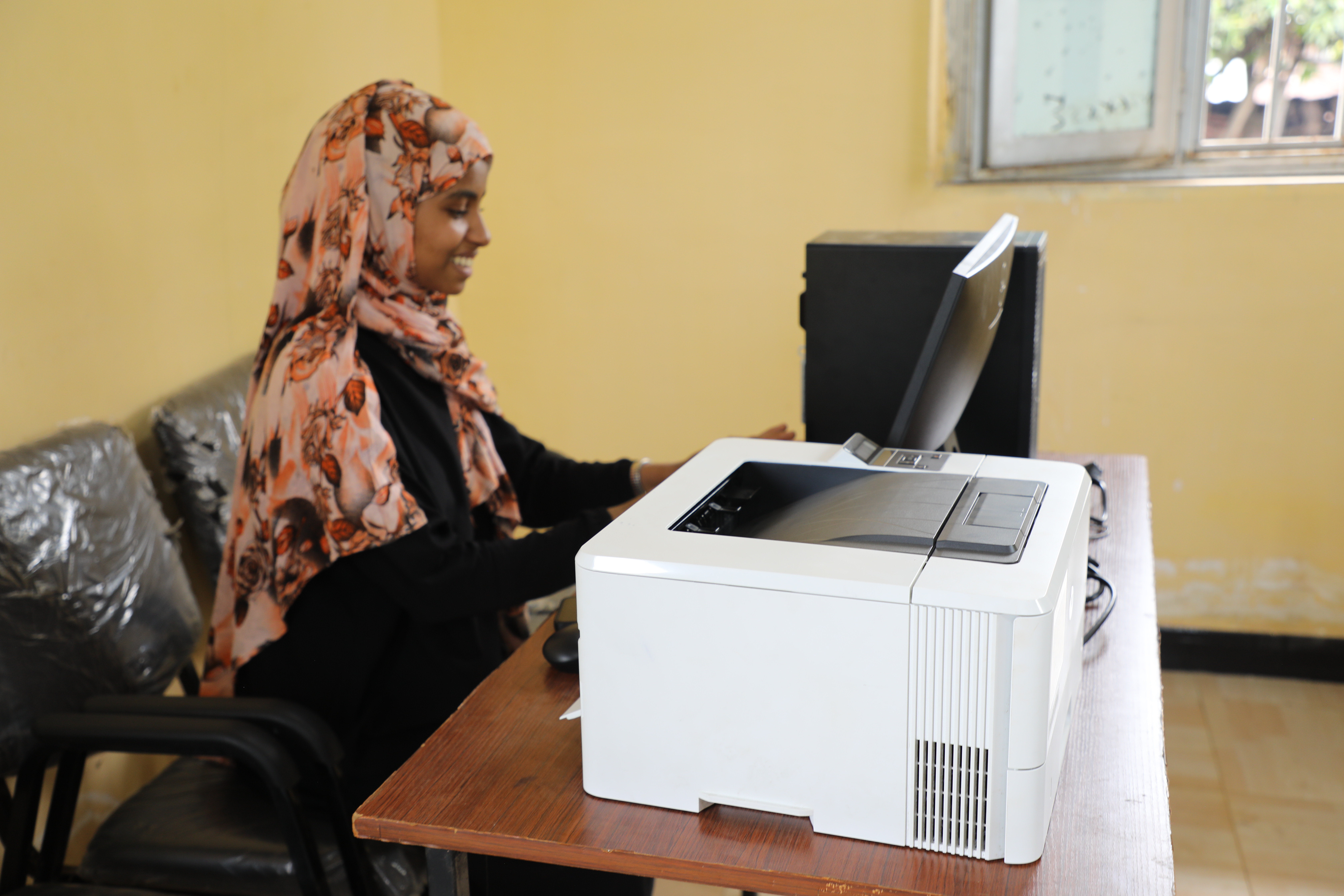 Jasbin recording data on the computer provided by World Vision for the child parliament