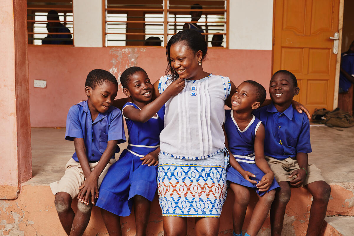 Teacher in school in Ghana with her students