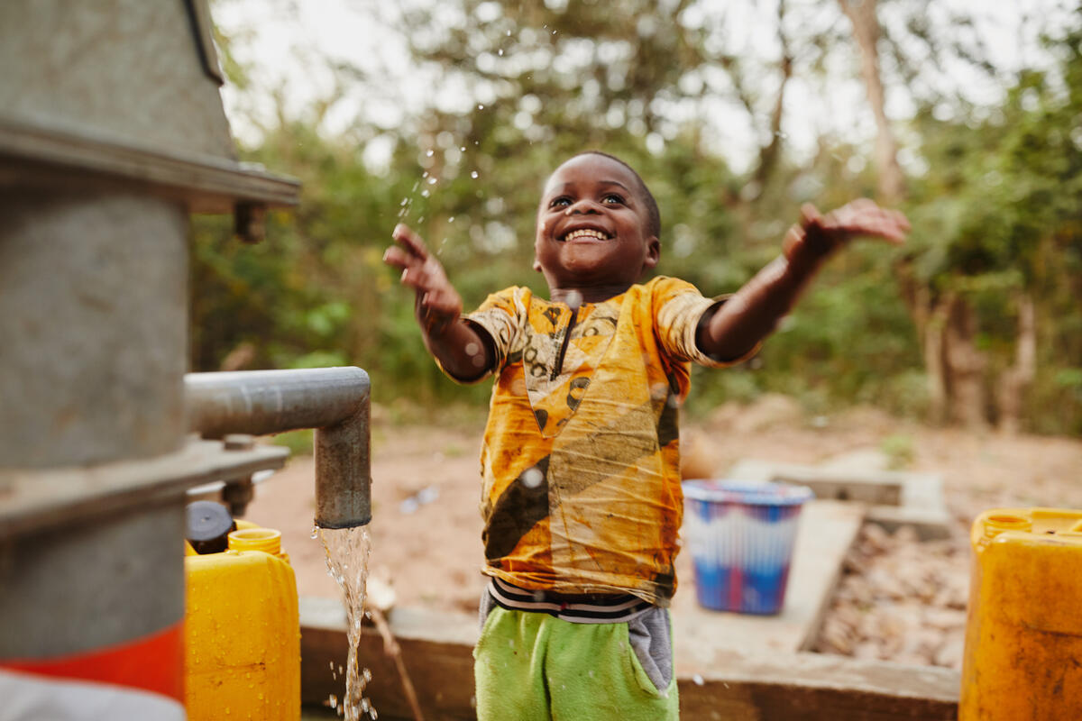 Child at community water pump in Ghana