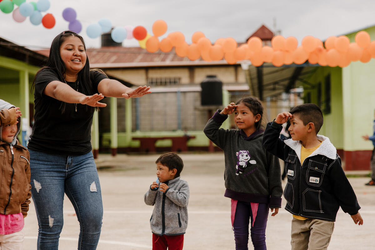 children playing with their teacher