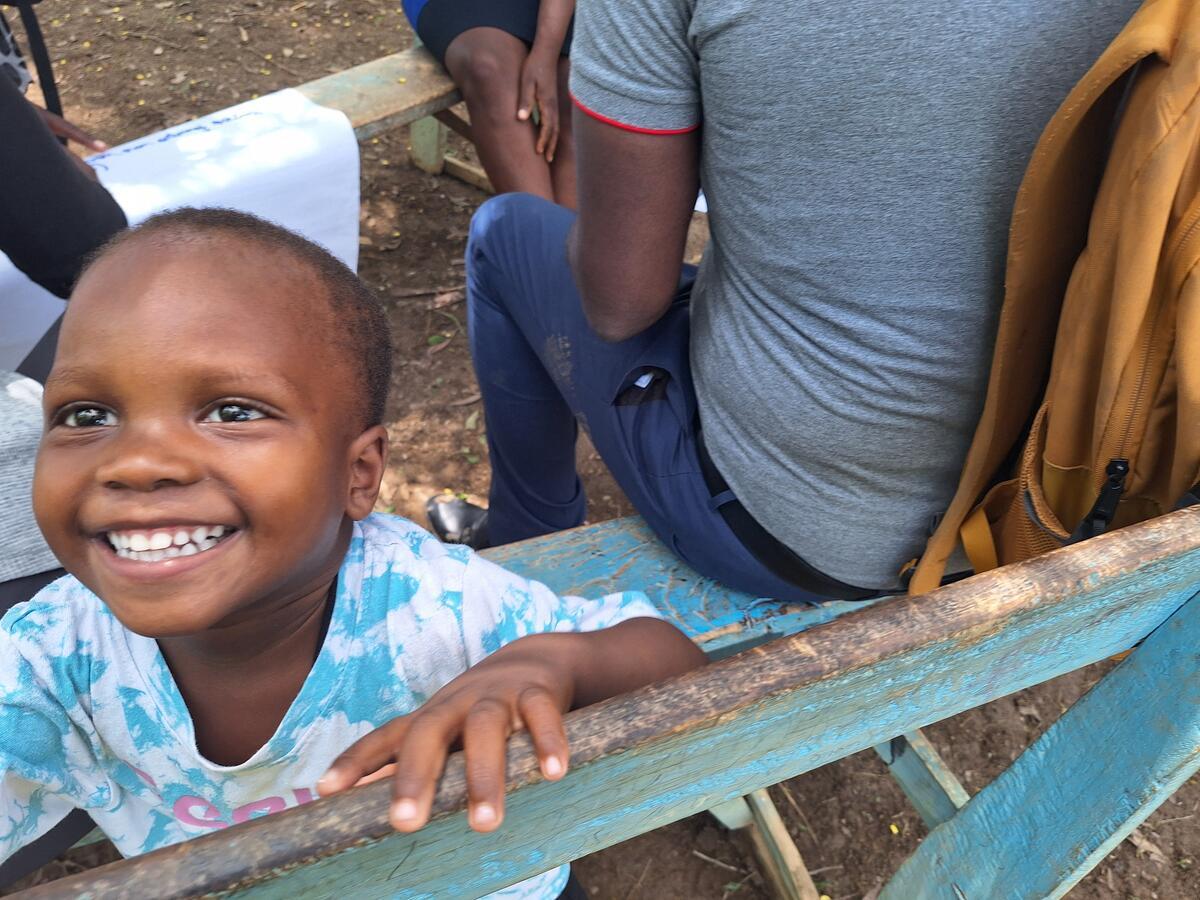Young child smiles and looks at the camera in Haiti
