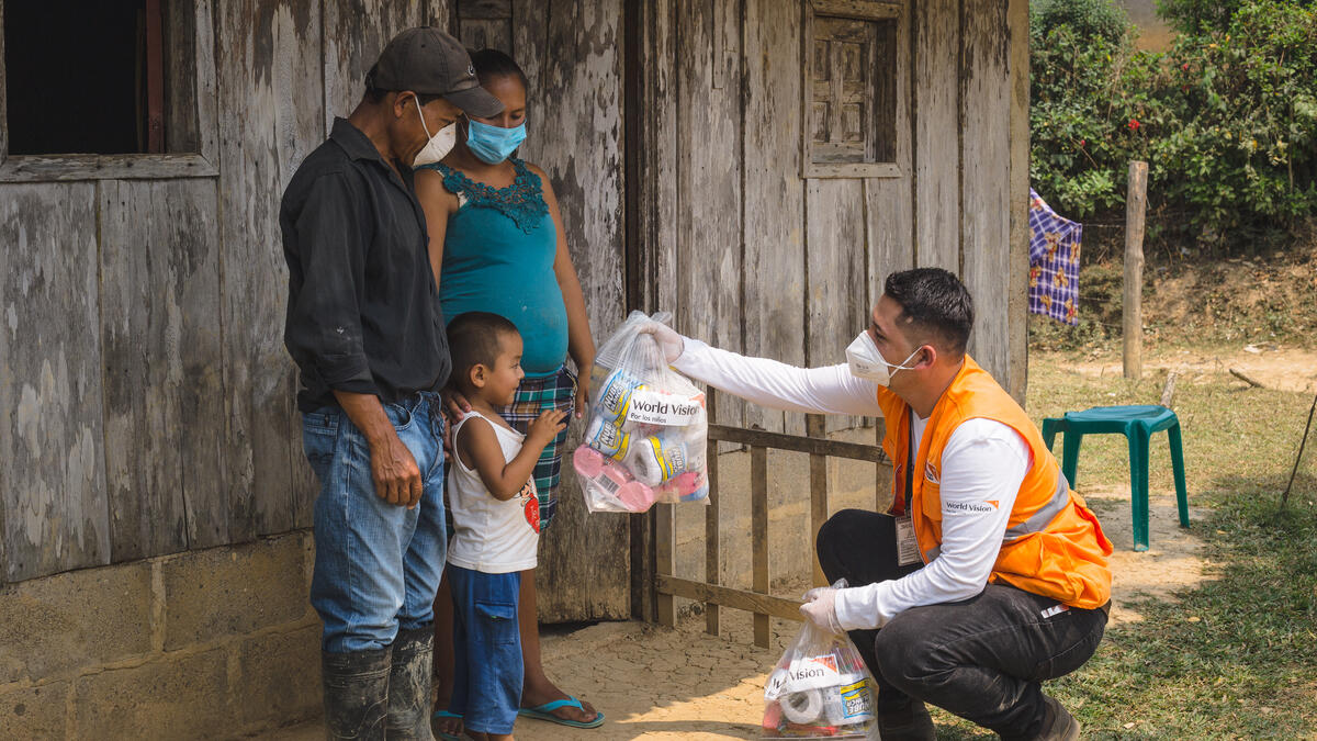 World Vision staff distribute food and hygiene supplies to family in Honduras