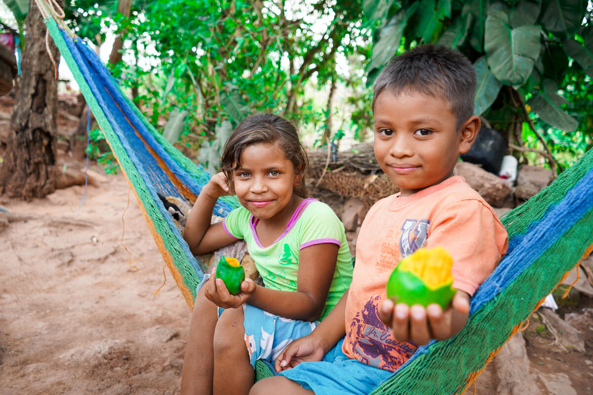 Children show the food they have prepared/