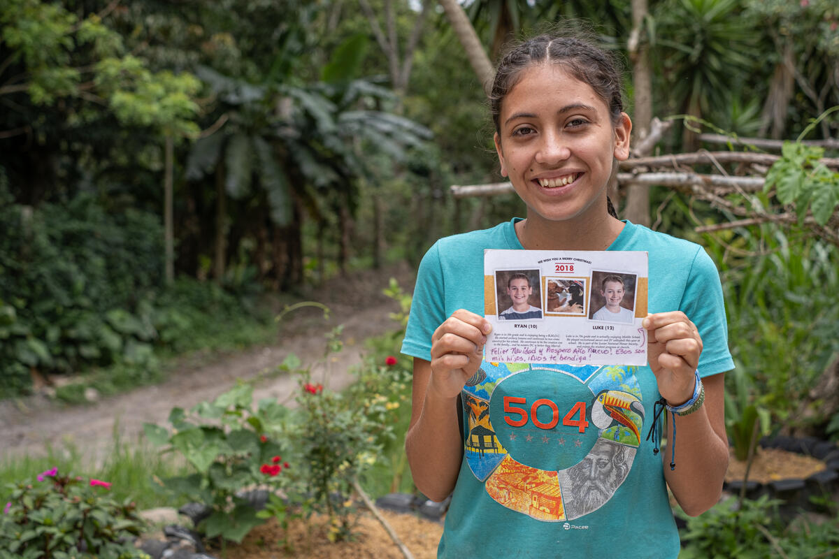 Danesi holds a photo of her sponsors