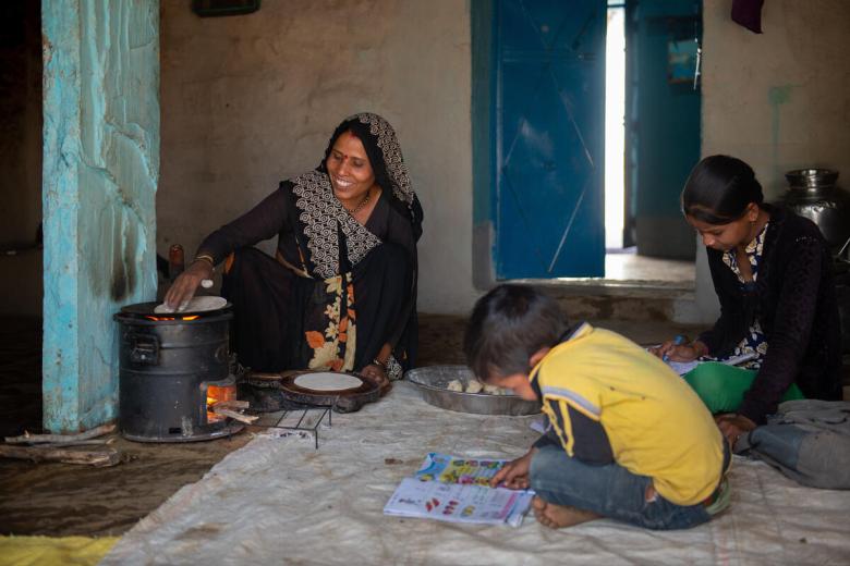 Family cooks with a fuel-efficient stove in India
