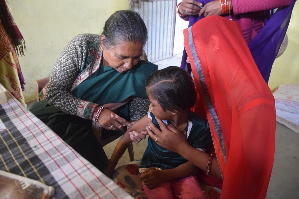 A child is immunised in India