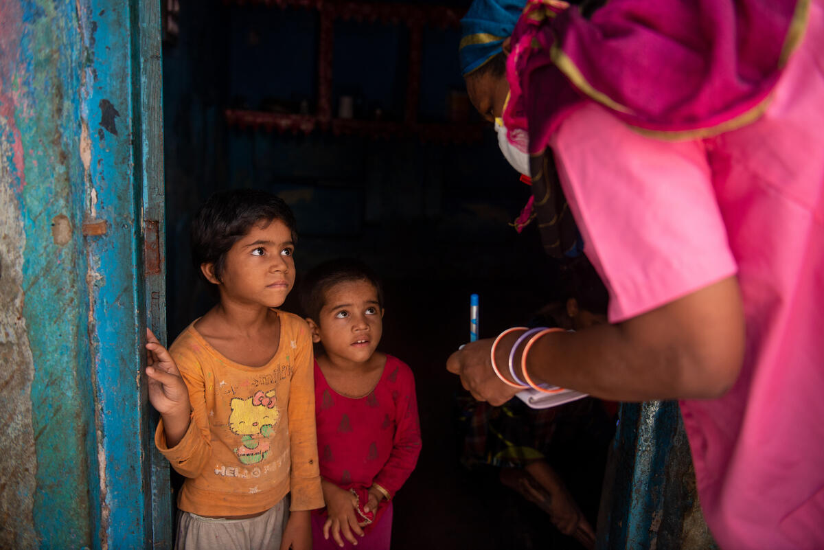 A community health worker helps children during times of COVID-19