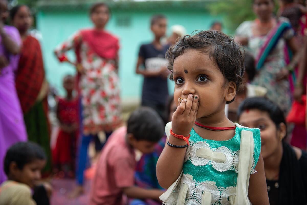 A child eats the delicious food prepared at the cooking demonstration in India.