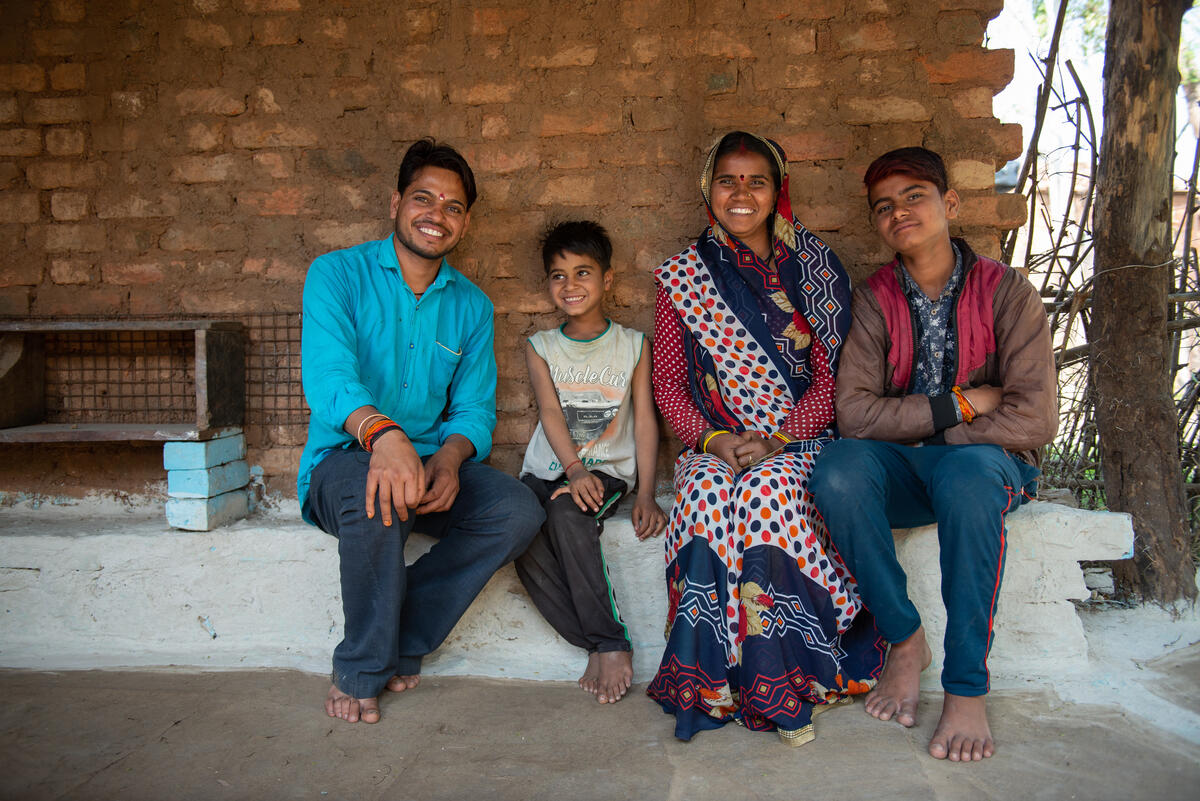 Hemant and his family outside their barbershop in India.