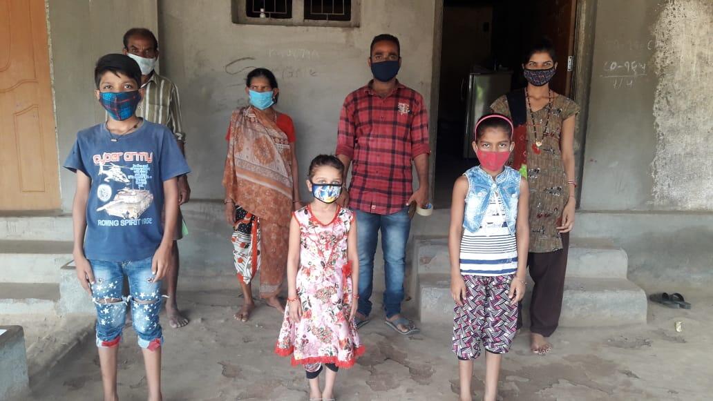 Family standing with masks