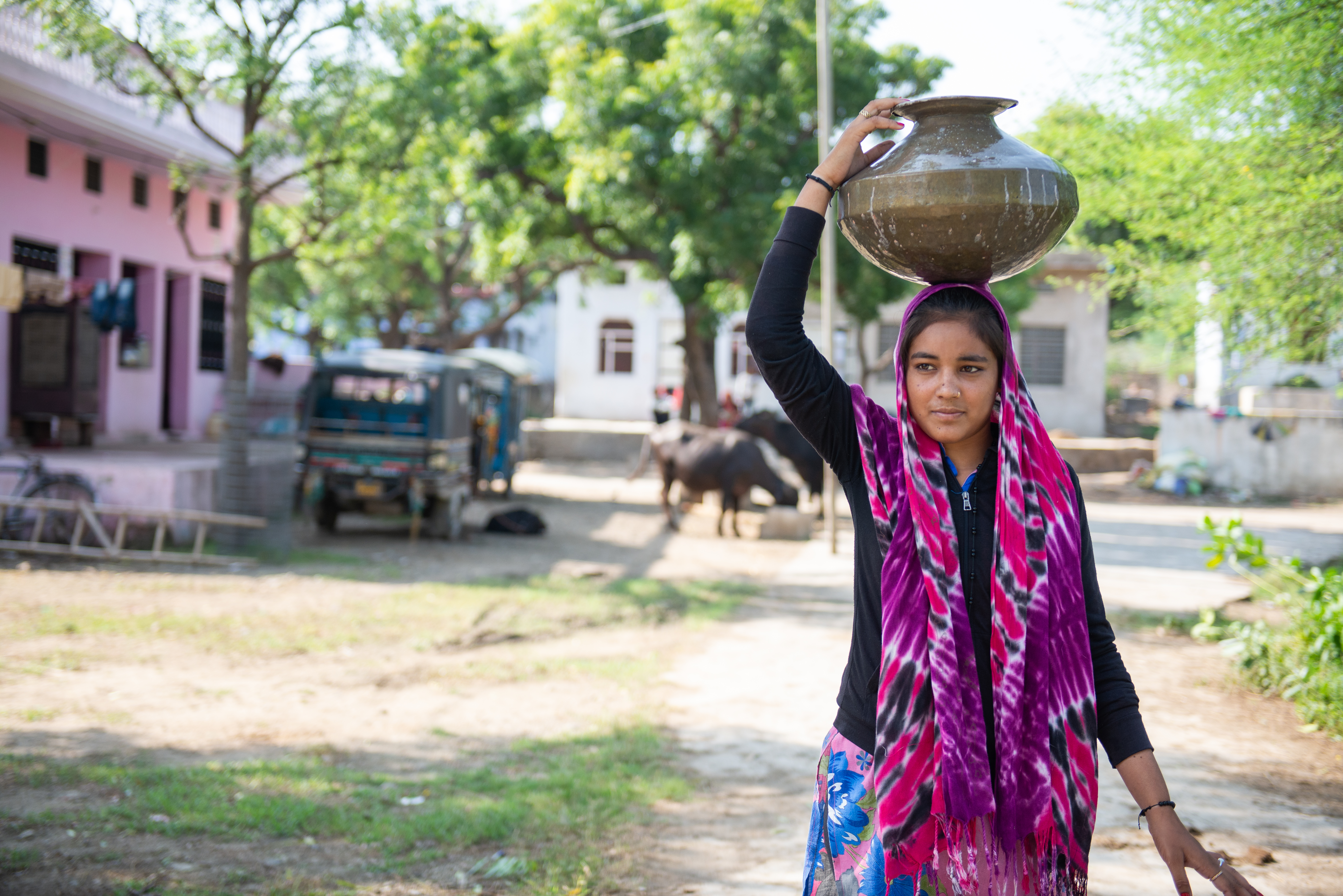 Mosam, 17, collects water during the morning.