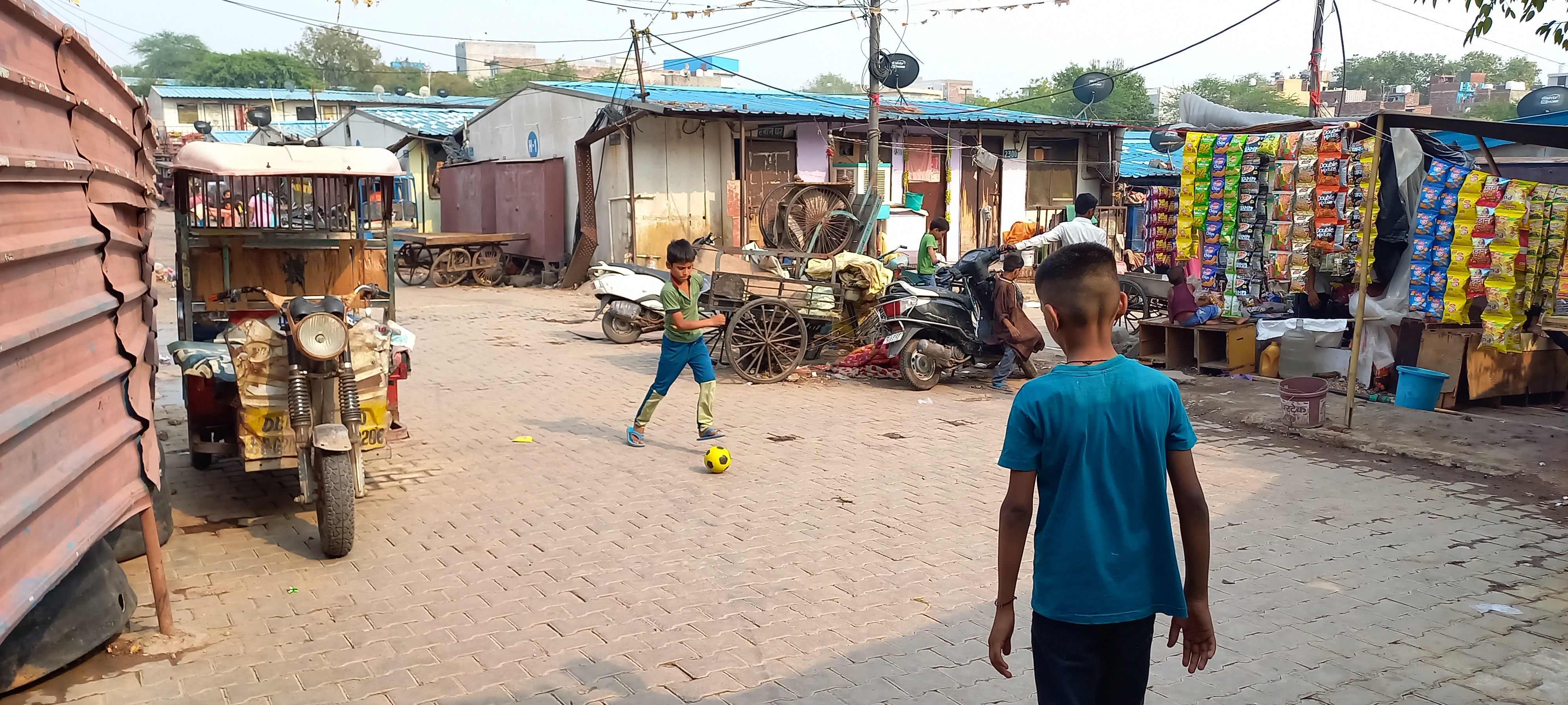 kids playing football in informal settlement