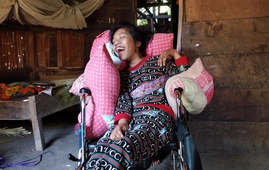 Yuliana smiling, happy with her new wheelchair 