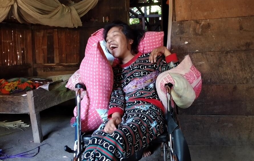 Yuliana smiling, happy with her new wheelchair