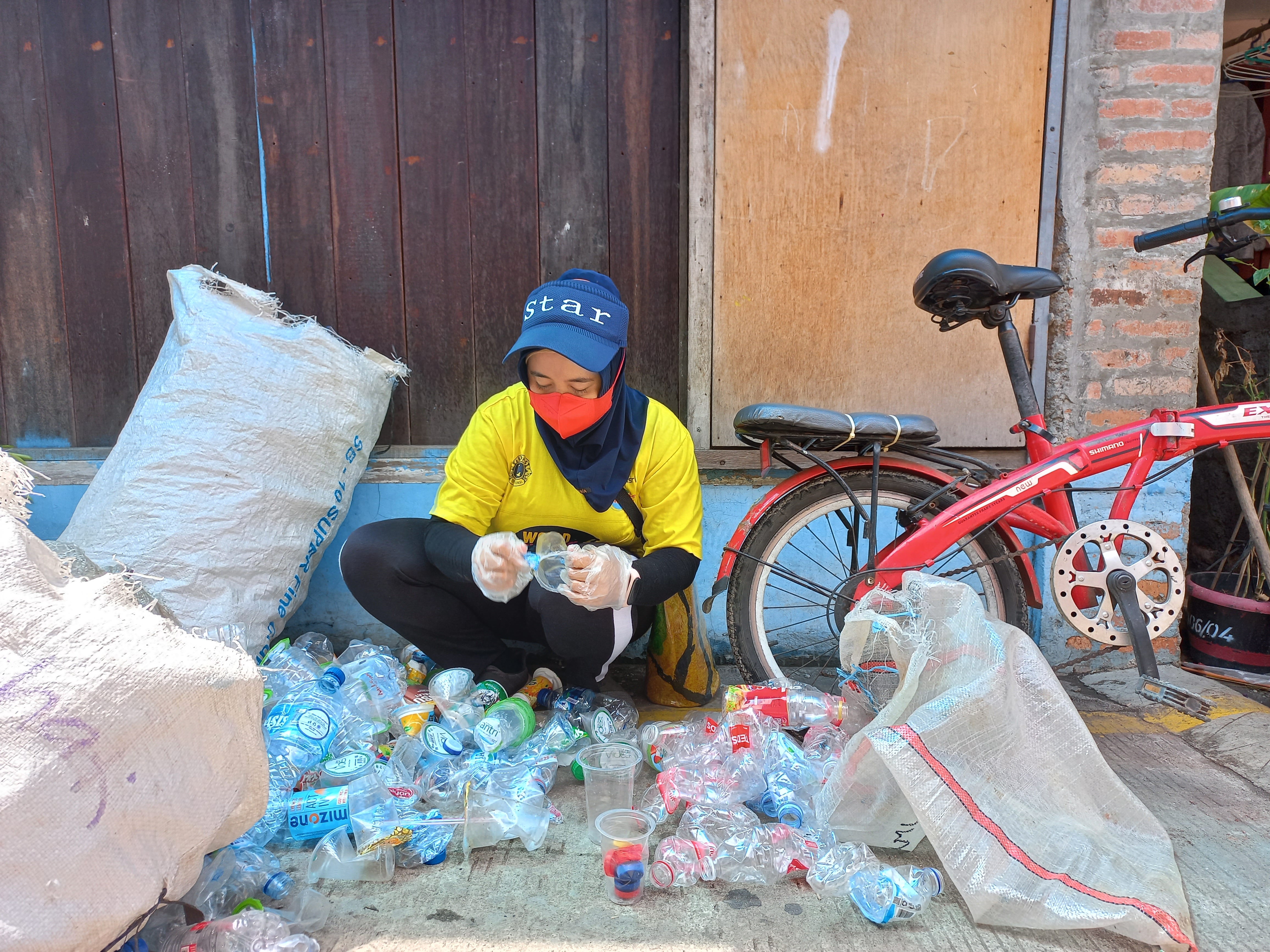 A woman separates plastic out of waste