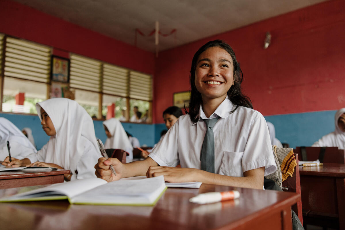 A girl in class smiling