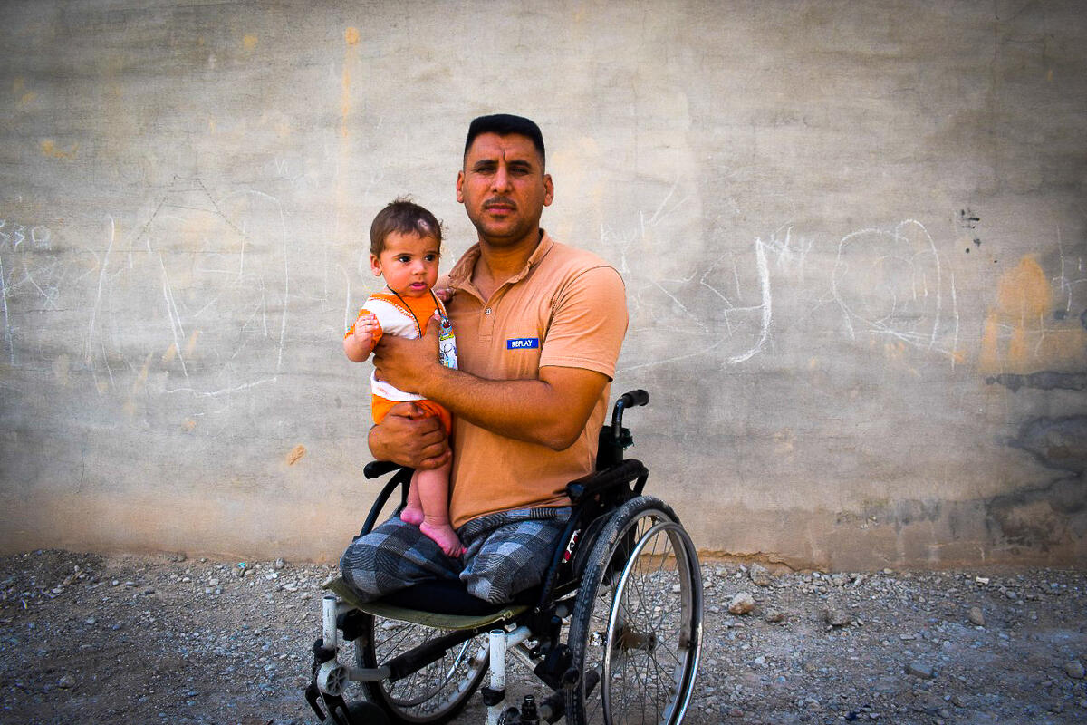 Taha, and his son, who benefits from disability-friendly WASH rehabilitation in Iraq