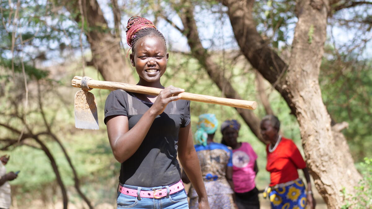 Ruth Jerotic carrying a hoe