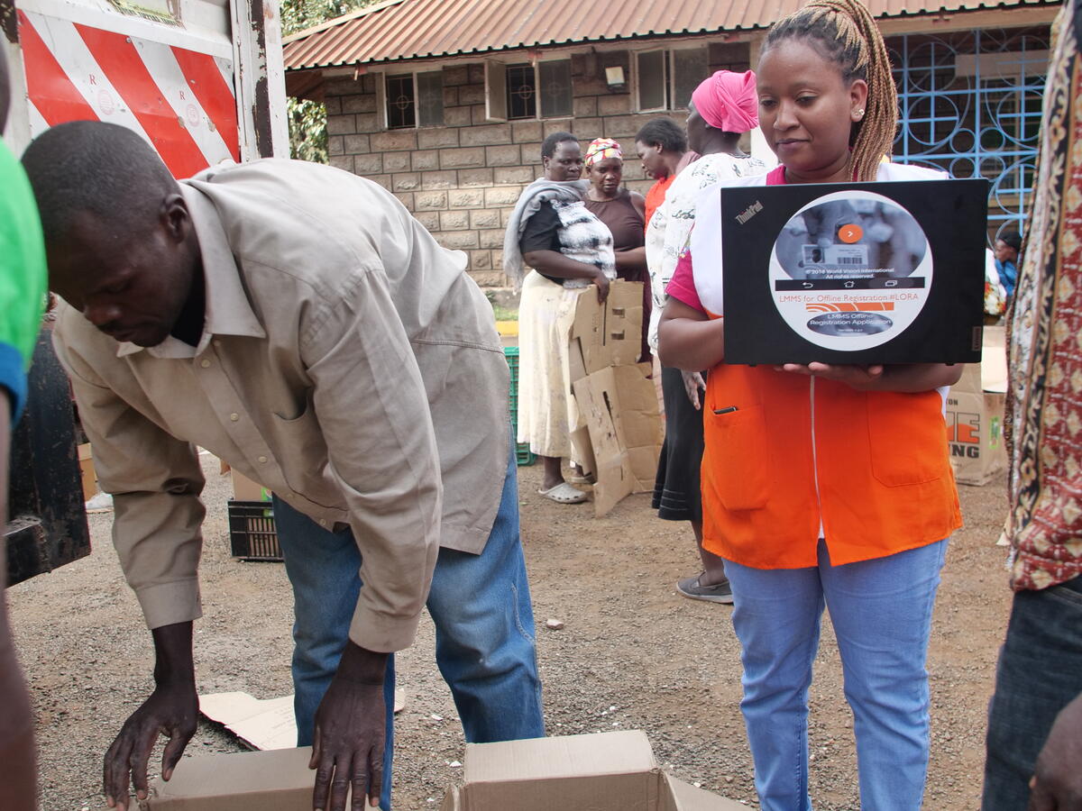 World Vision staff using laptop to count donations