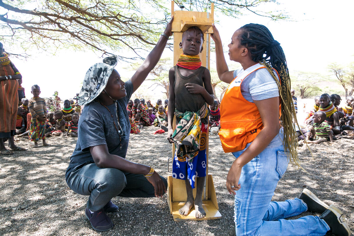 A child in Purapul, Kenya is measured to assess for signs of wasting during a nutritional outreach