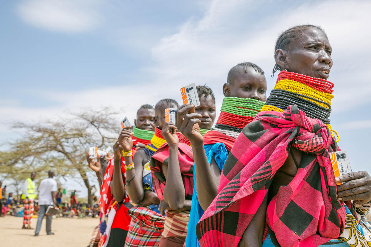 Kenyans line up with their LMMS cash cards 