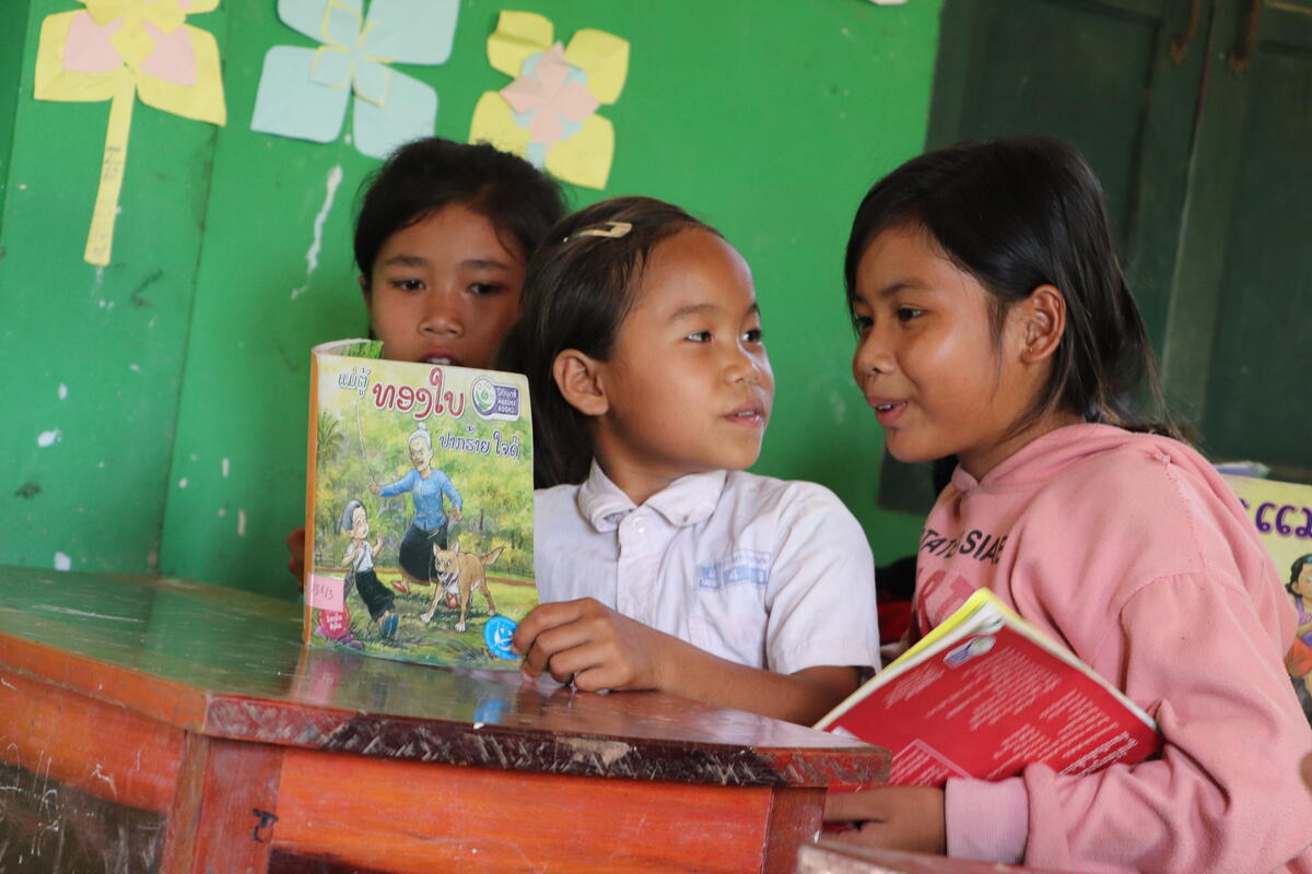 Kam loves to choose books from the World Vision provided library.