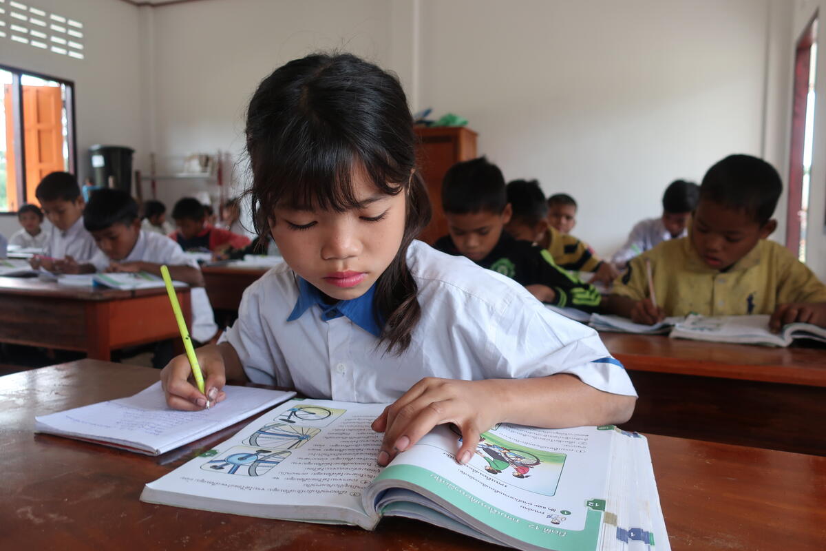 Child in Laos learns from a book