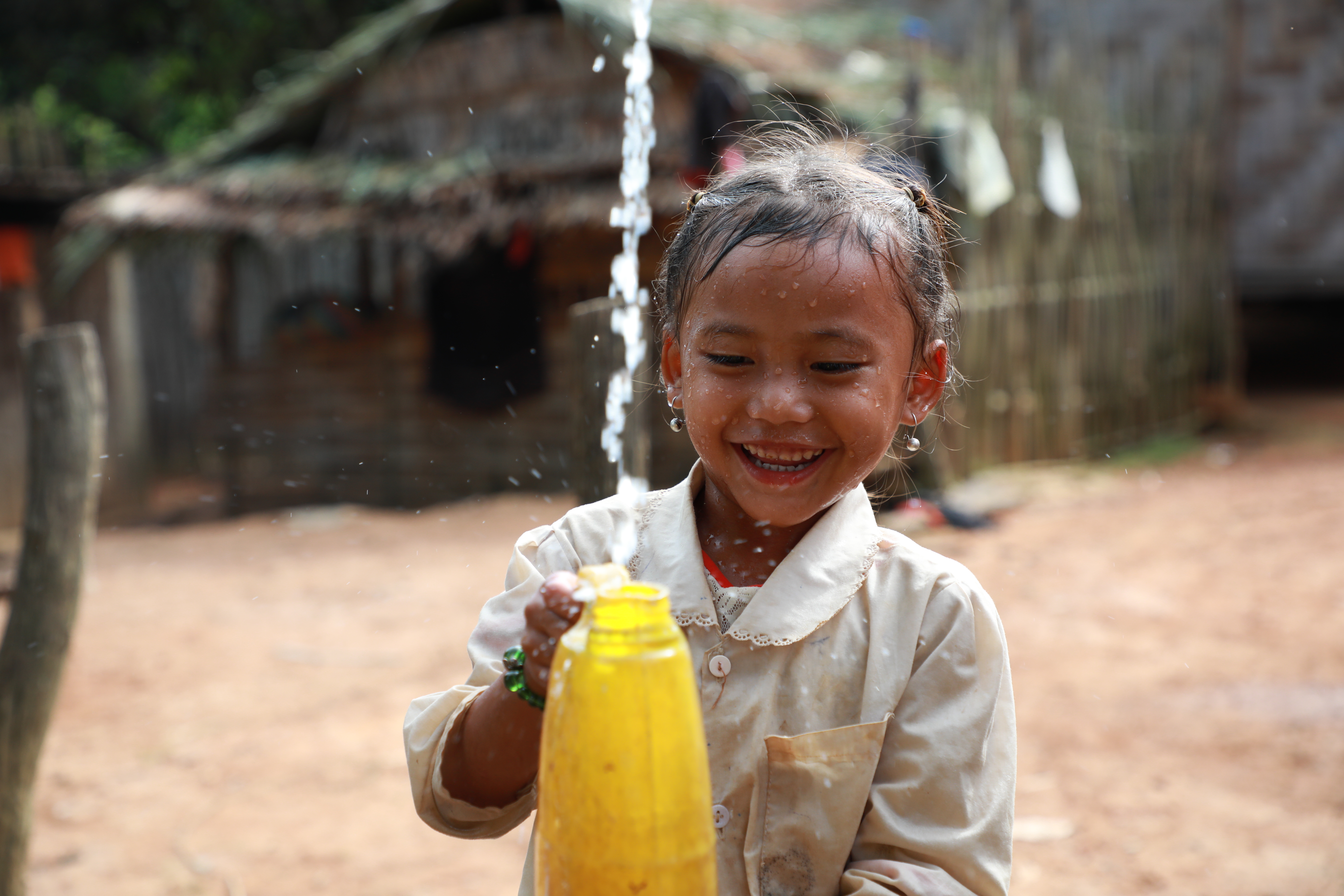 A child fetching water from a tap