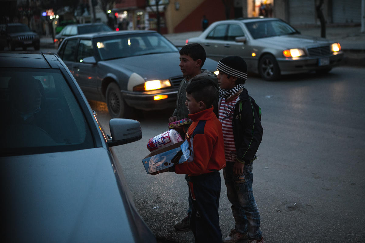 Young Syrian boys sell items on the street